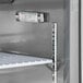 An Avantco stainless steel sandwich prep refrigerator with a thermometer on a shelf.