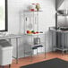 A Regency chrome baker's rack with wire and stainless steel shelves in a kitchen.