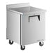 A silver True worktop freezer with black wheels.