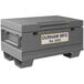 A gray Durham Mfg steel job site box with a white label.