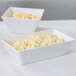 Two white rectangular American Metalcraft melamine bowls filled with macaroni and cheese.