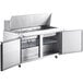 An Avantco stainless steel commercial sandwich prep table with two doors open.