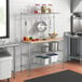 A kitchen with a Regency chrome wire shelf and utensils.