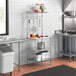 A Regency baker's rack in a kitchen with stainless steel shelves and a white plastic cutting board.