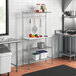 A Regency chrome wire shelf with a plastic cutting board on a kitchen counter.