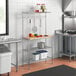 A kitchen with a Regency chrome wire shelf with a hardwood cutting board on the counter.