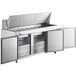 An Avantco stainless steel commercial kitchen refrigerator with 3 doors and a cutting board on a counter.