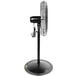 A Tornado black metal industrial pedestal fan on a stand.