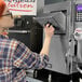 A woman using an AutoFry MTI-10XL ventless fryer.