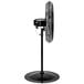 A Tornado black metal pedestal fan on a stand.