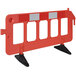 An orange and black Vestil interlocking barrier with black legs.
