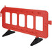An orange plastic barrier with black legs.