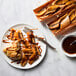 A plate of food with Wildwood Grilling cedar-wrapped food and a fork and sauce.