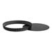 A black metal round fluted quiche pan with a curved edge and removable round bottom.