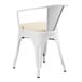 A Lancaster Table & Seating white outdoor arm chair with a cushion on top.