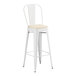 A white Lancaster Table & Seating outdoor cafe barstool with a tan cushion.