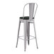 A Lancaster Table & Seating gray metal outdoor cafe bar stool with black cushion.