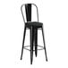 A Lancaster Table & Seating black metal outdoor cafe bar stool with black cushion.