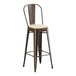 A brown metal Lancaster Table & Seating outdoor cafe barstool with a tan cushion.