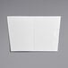 A white poly-coated paper with a dotted line and a hole in the middle.