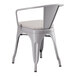 A Lancaster Table & Seating grey metal outdoor arm chair with a grey cushion.