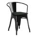 A Lancaster Table & Seating black metal outdoor arm chair with a black cushion.