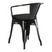 A Lancaster Table & Seating black outdoor arm chair with black cushion.