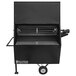 A black Holstein Manufacturing charcoal grill with a metal grate and wheels.