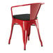 A red Lancaster Table & Seating outdoor arm chair with black cushion on a patio.
