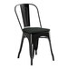 A Lancaster Table & Seating black metal outdoor cafe chair with a black cushion.