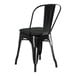 A Lancaster Table & Seating black metal outdoor cafe chair with black cushion.