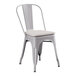 A Lancaster Table & Seating gray metal outdoor cafe chair with a gray cushion.