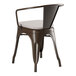 A brown metal Lancaster Table & Seating outdoor arm chair with a gray fabric cushion.