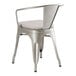 A Lancaster Table & Seating silver metal arm chair with a gray cushion.