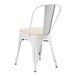 A Lancaster Table & Seating white metal outdoor cafe chair with tan cushion.