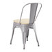 A Lancaster Table & Seating gray metal outdoor cafe chair with a tan cushion.