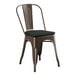 A brown metal Lancaster Table & Seating outdoor cafe chair with a black cushion.