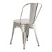 A Lancaster Table & Seating metal chair with a gray cushion.