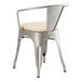 A Lancaster Table & Seating metal arm chair with a tan cushion on a white background.