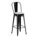 A Lancaster Table & Seating black outdoor cafe barstool with a gray cushion.