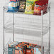 A Regency chrome wire rack with snacks on it.