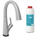 A Zurn Elkay Avado lustrous steel deck mount kitchen faucet with a curved silver lever next to a white bottle.