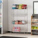 A Regency chrome retail storage display stand with shelves of snacks and drinks.
