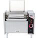 An APW Wyott vertical conveyor bun grill toaster on a counter in a professional kitchen with the lid open.