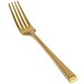 A close-up of a Front of the House Parker Matte Brass Salad/Dessert Fork.