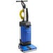 A blue and black Clarke MA10 12E walk behind cylindrical floor scrubber.