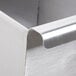 A close up of the corner of an Advance Tabco stainless steel commercial sink.