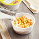 A bowl of Kellogg's Corn Pops cereal with milk being poured into it.