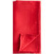 A red folded Oxford cloth napkin.