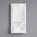 A white cloth folded on a gray surface.